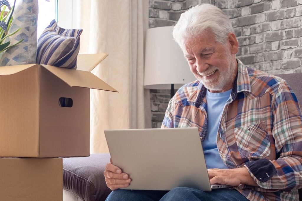Senior man using a laptop while researching spring senior living transition tips near Hickory Valley